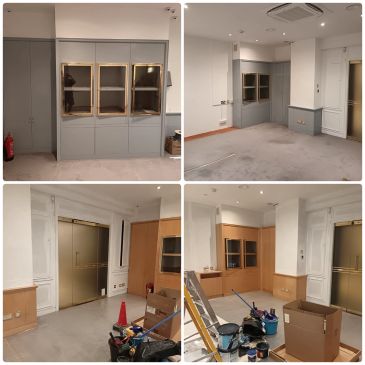 Empty room with cabinets and construction supplies.