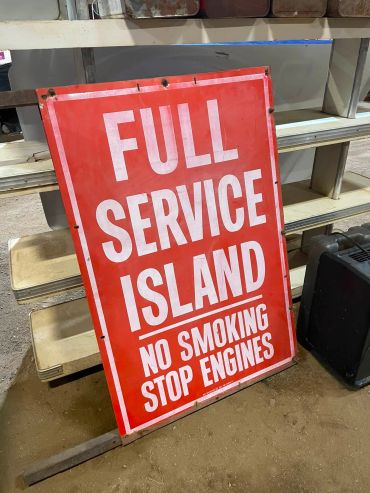 Sign for Full Service Island with smoking and engine guidelines.