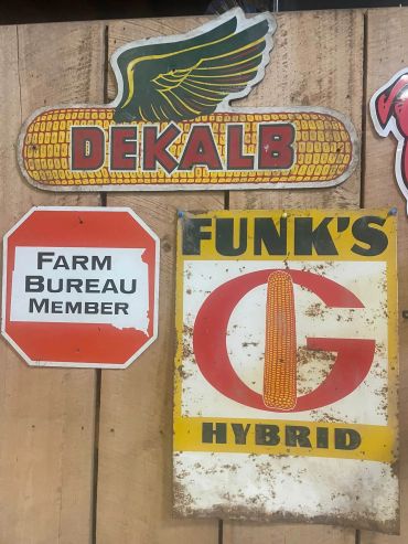 Vintage agricultural signs on wooden wall.