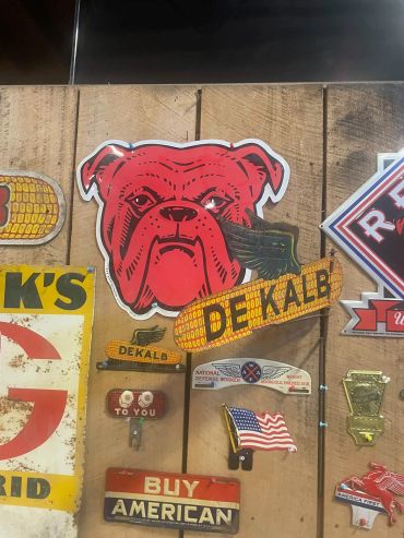 Vintage red bulldog Dekalb sign on wooden wall.