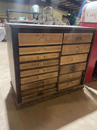Vintage wooden cabinet with multiple drawers.