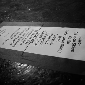 Setlist for a live music performance laid on a stage floor.