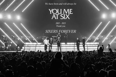 Black and white farewell concert of You Me At Six with a large crowd and stage lights.