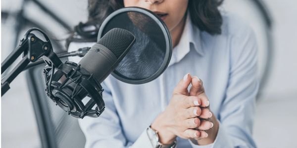 woman in front of podcast microphone