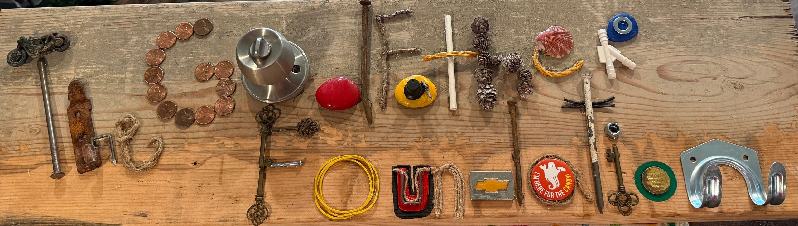 Various objects arranged to spell 'GO FATHER FROM TOWN'.