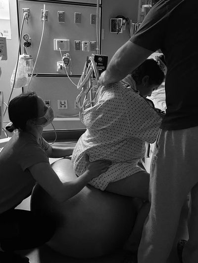 Doula providing birth support at a hospital. Labour and birth doula, hospital birth, labour support.