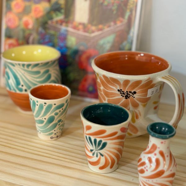 Brilliant Orange yellow and greeen pottery functional cups with swirling glaze in rust colors.