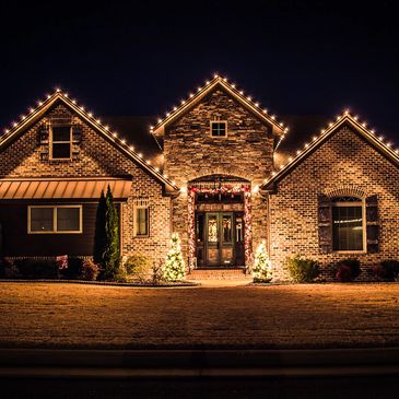 LED Christmas Lights installed along the roof of a home