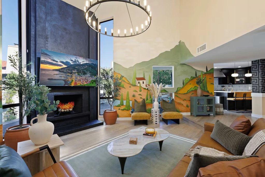 Cozy living room with mountain mural and modern decor.