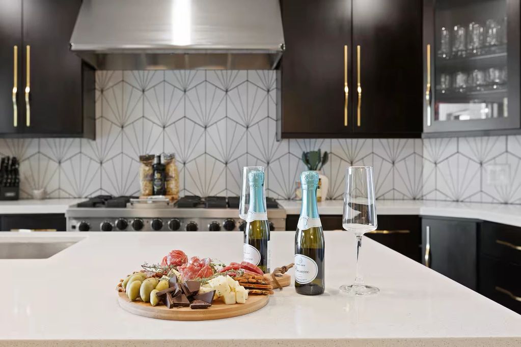 Luxurious kitchen island with charcuterie and sparkling wine.