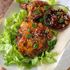 Asian inspired sesame hoisin chicken ribs displayed on lettuce
