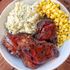 Tender, hickory-smoked chicken ribs with herbed mashed potatoes and a side of corn for a hearty meal