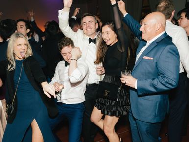 Group of people dancing and celebrating at a party.