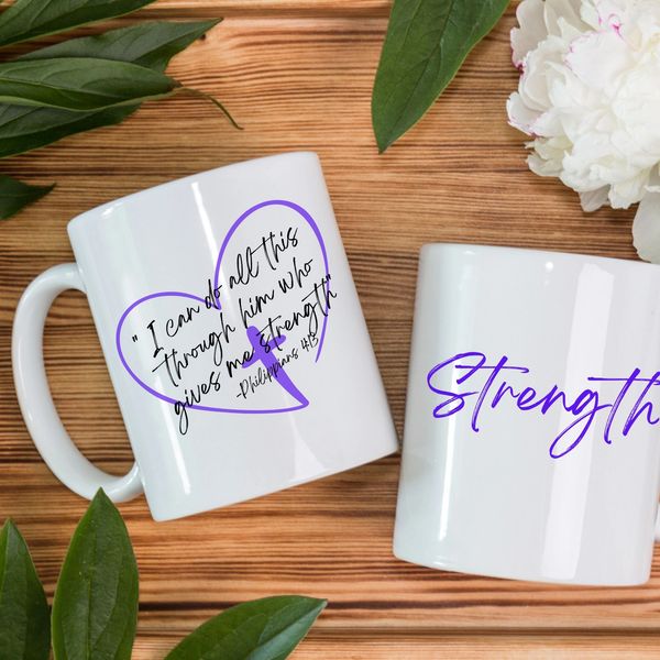 Two white mugs with inspirational quotes and purple designs on a wooden table.