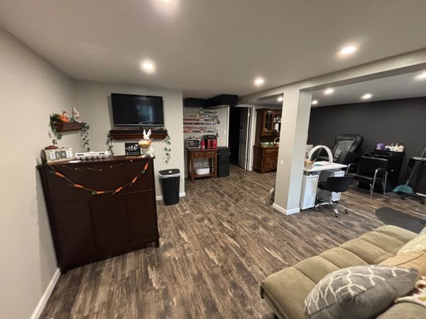 Cozy basement setup with a nail salon station and decorative Easter bunny accents.