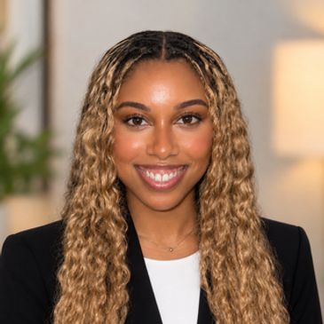 Smiling woman with long wavy hair in professional attire.