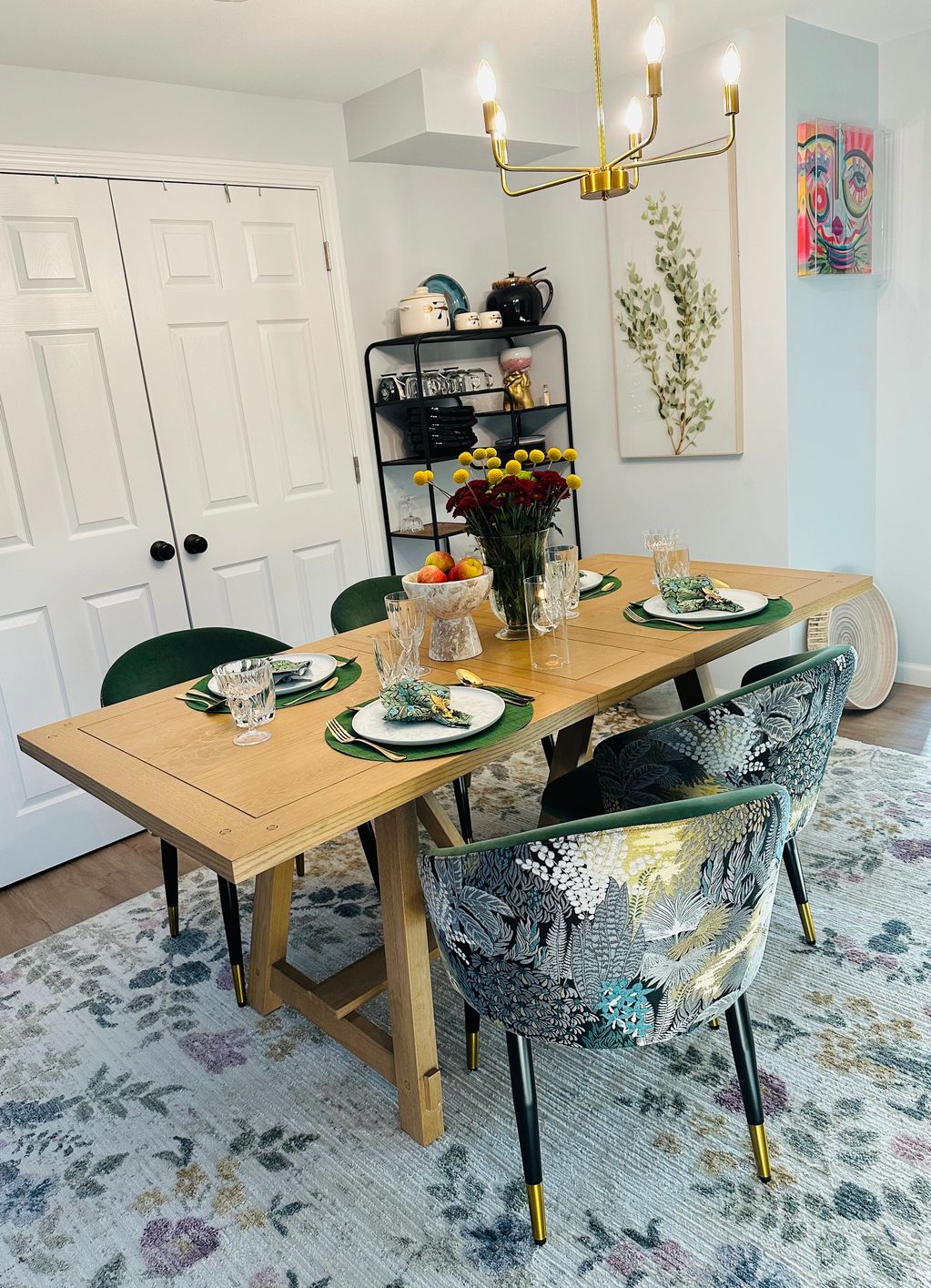 Elegant dining room with floral chairs, wooden table, and vibrant wall art.