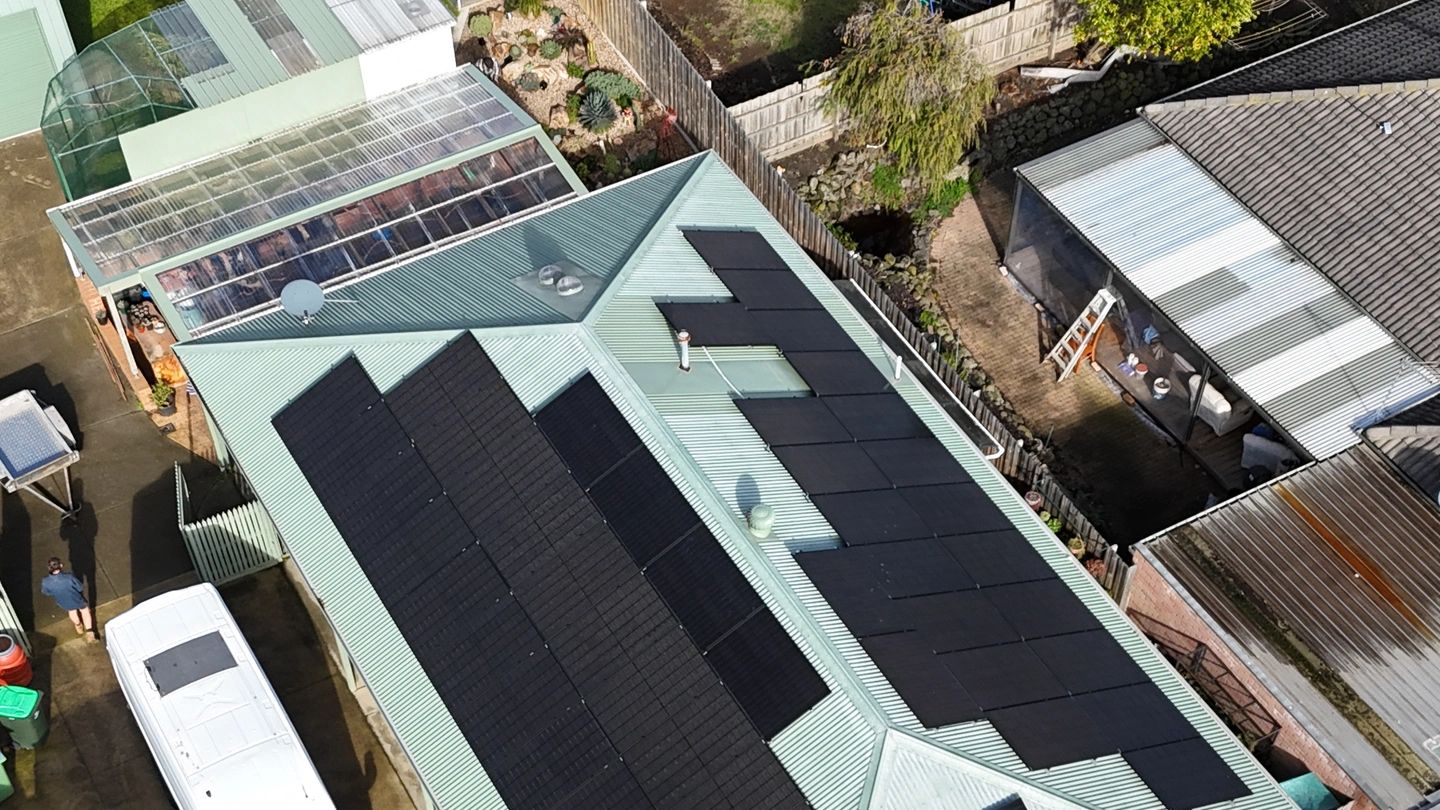Aerial view of rooftops with solar panels installed.