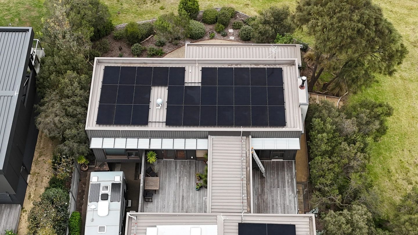 Top view of house with solar panels on the roof.