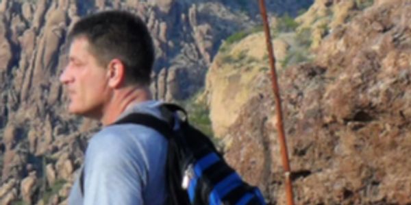 Artist Robert Wood stops on the trail while hiking in the Superstition Mountains of Arizona