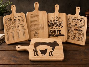 Five wooden cutting boards with engraved kitchen designs and quotes.