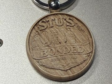 Wooden keychain with Stu's Own Bonded Bourbon Bar design.