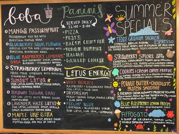 Colorful chalkboard menu with boba, paninis, and summer specials.