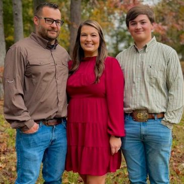 A family portrait outdoors in fall attire.
