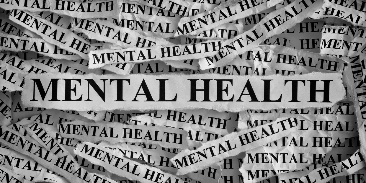 Picture of ripped strips of paper that say "Mental Health."