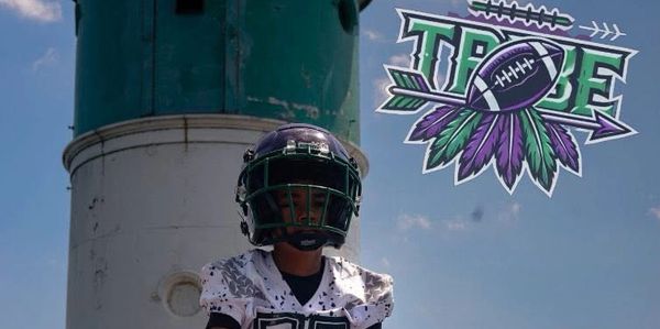 Young football player in uniform with helmet.