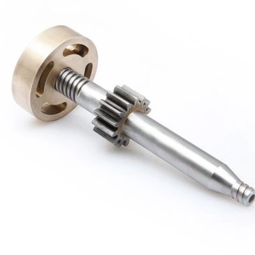 Metal mechanical shaft with gears and a bronze wheel on a white background.