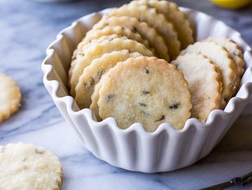 Lavender shortbread cookies in scalloped white dish