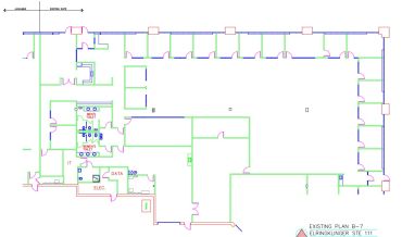 Architectural floor plan with rooms and corridors in blue and green lines.