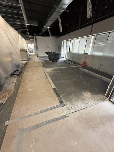 Interior space under renovation with construction materials and tools.