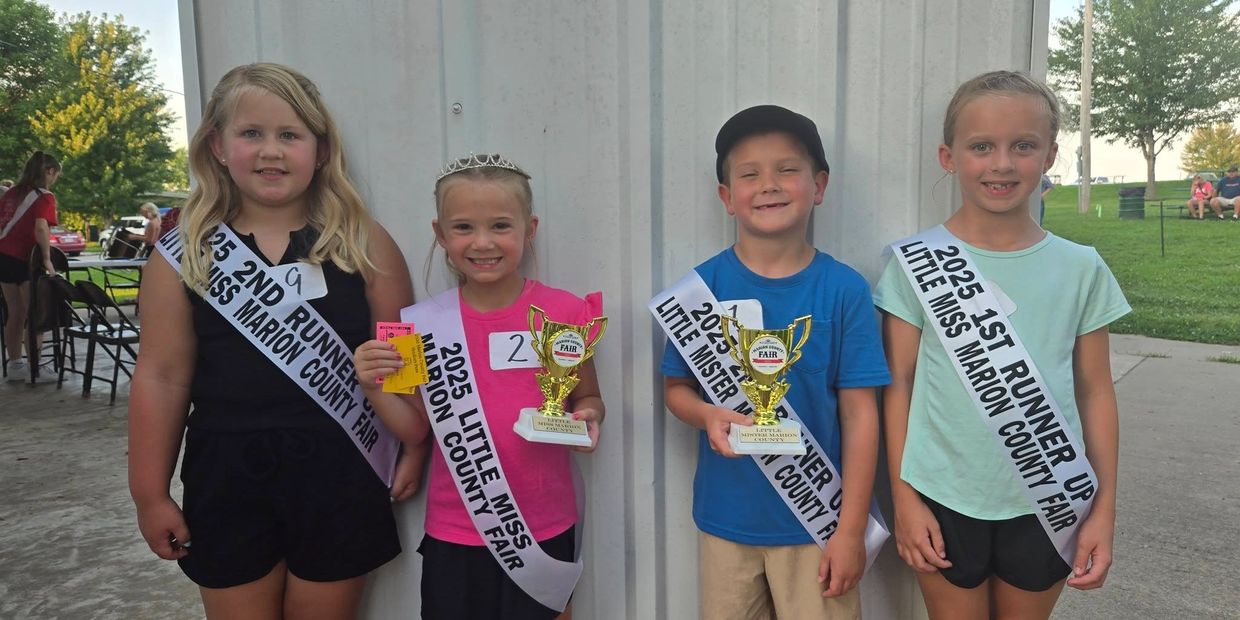 Four children posing with trophies and sashes from the 2025 Marion County Fair.