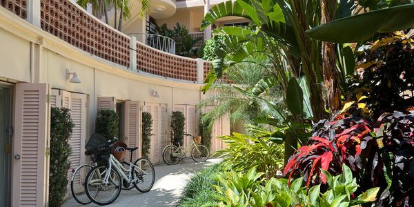 369 South Lake Drive, Palm Beach, Park Place, bikes near poolside cabanas, lush foliage