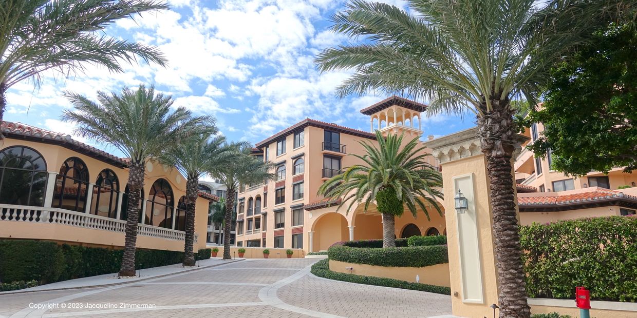 Palm tree lined entrance to the L'Ermitage, Palm Beach, condos for sale