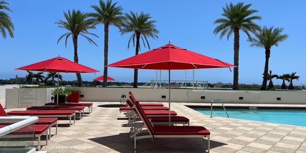 The Plaza of the Palm Beaches, 525 and 529 S Flagler Drive, West Palm Beach, pool with red umbrellas