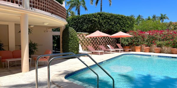 Steps to pool, pink chairs and umbrellas by pool, Park Place, 369 S Lake Drive, Palm Beach