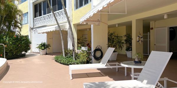 Two lounge chairs by the pool, 389 S Lake Dr, Palm Beach, condos for sale