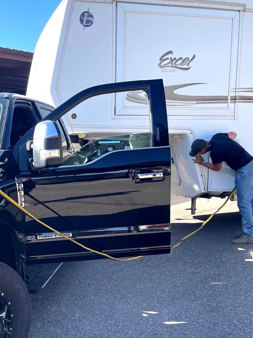 Using truck battery to power fifth wheel with dead RV battery before loading for transport.