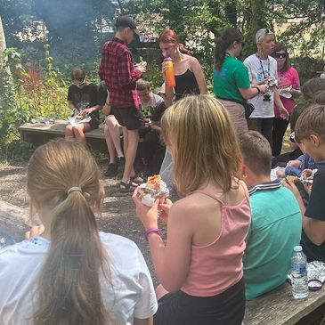 Group of young people around a campfire