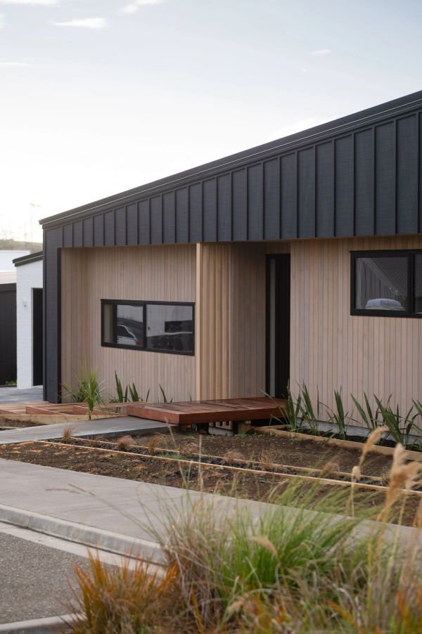 Modern house with wooden and black panel exterior.