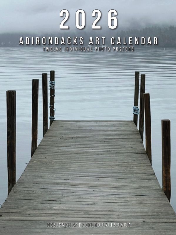 Calm wooden dock extending into misty Adirondack lake, 2026 art calendar cover.