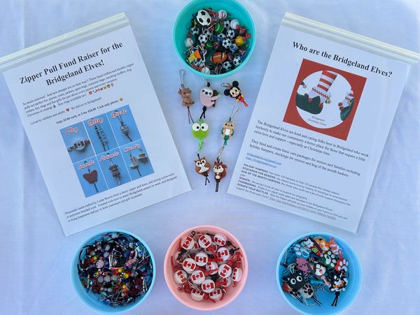 Fundraiser display with Bridgeland Elves zipper pulls and description sheets.
