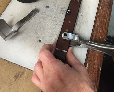 Michael customizing a nickel free belt for a customer.