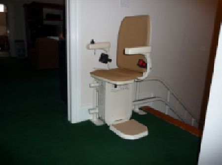 Platinum stair lift parked ready for use at the top of the stairs