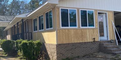 A recent screenporch to sunroom conversion with T1-11 wood siding and Reliabilt 4’x4’ sliding window
