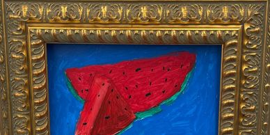 Painting of two watermelon slices on a blue background in a gold ornate frame.