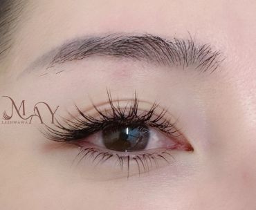 Close-up of a well-groomed eyebrow and long eyelashes.